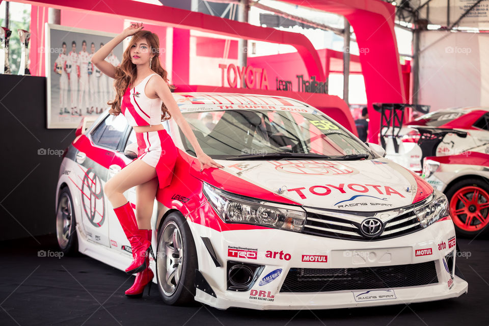 Pretty racing girl with Toyota racing car