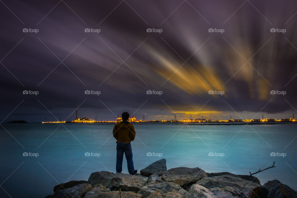 a man at the beach on sunset time