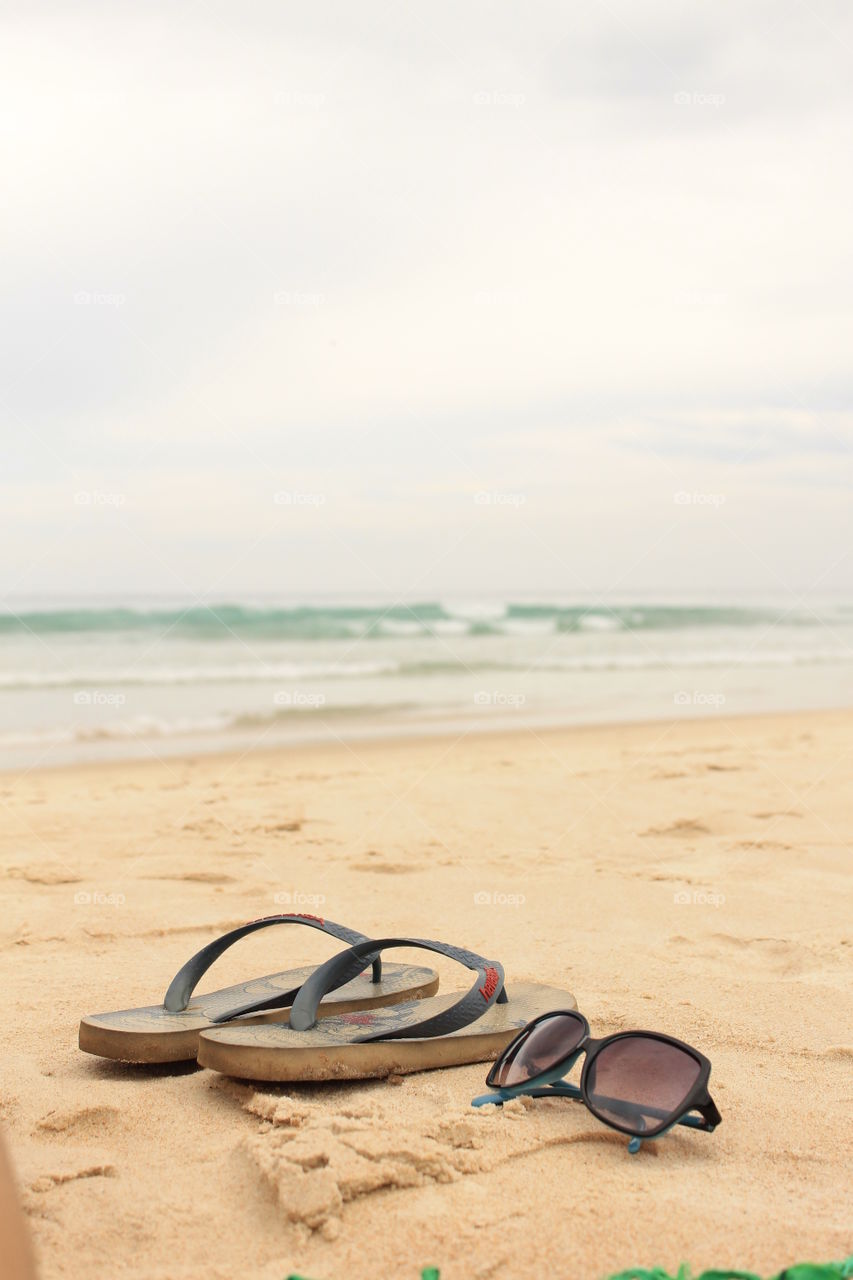 New Kids at the Beach. Flip Flops and sunglasses at the beach. Cloud day but no less beautiful.