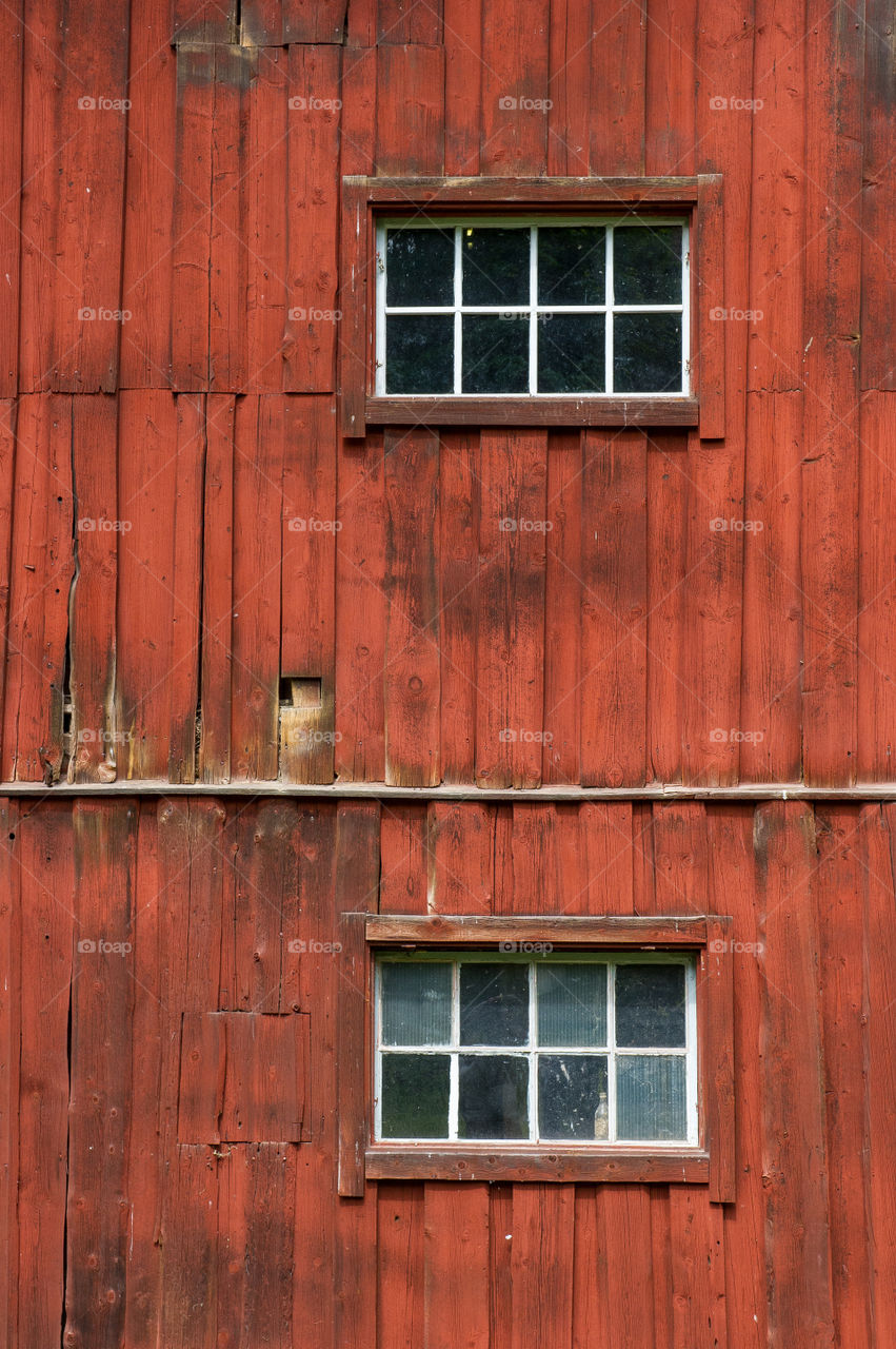 windows on a red wooden facade