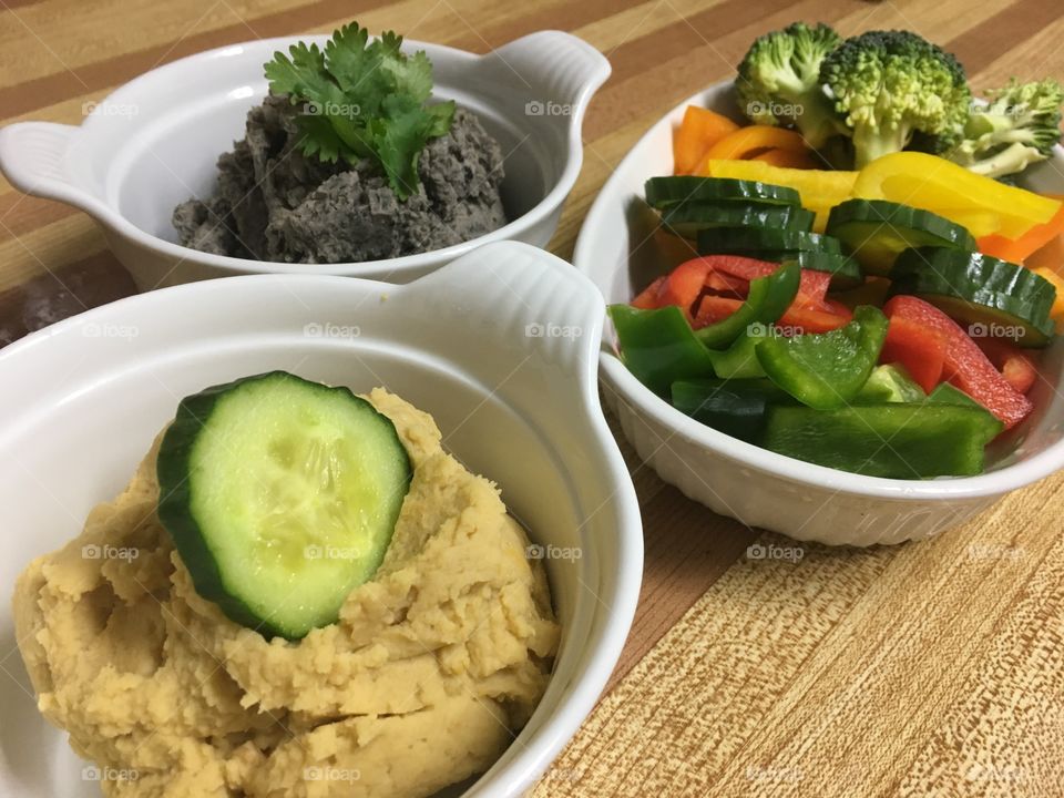 Healthy dips and veggies. The first dip is Black Bean with zero oil or sugar and the second is tahini with no oil and sugar as well, paired with peppers, broccoli and cucumbers so yummy and good for you