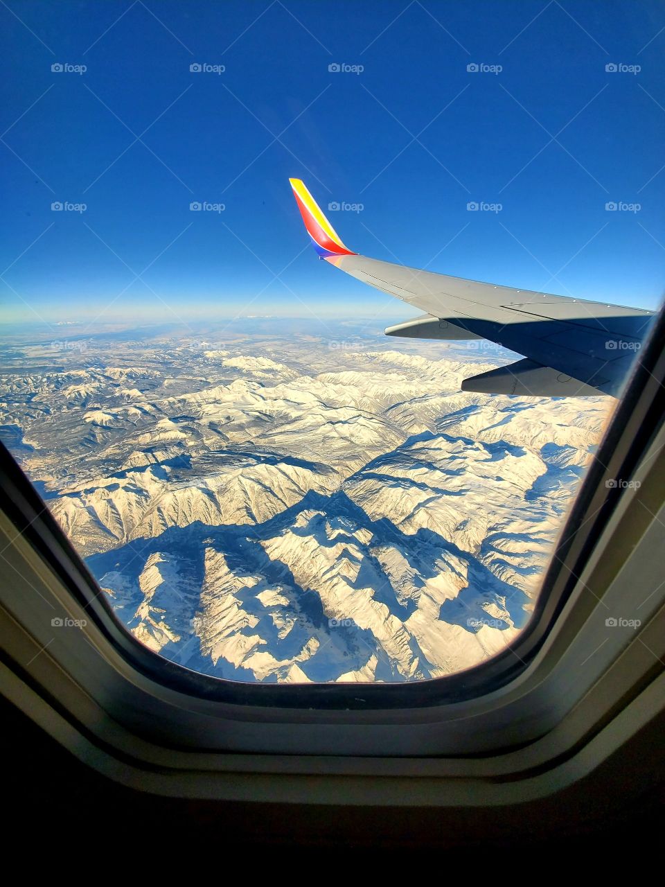 Early flight over snow covered mountains