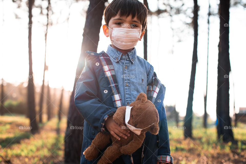 Little kid with toy wearing air mask - Corona Virus, Global Warming 2020