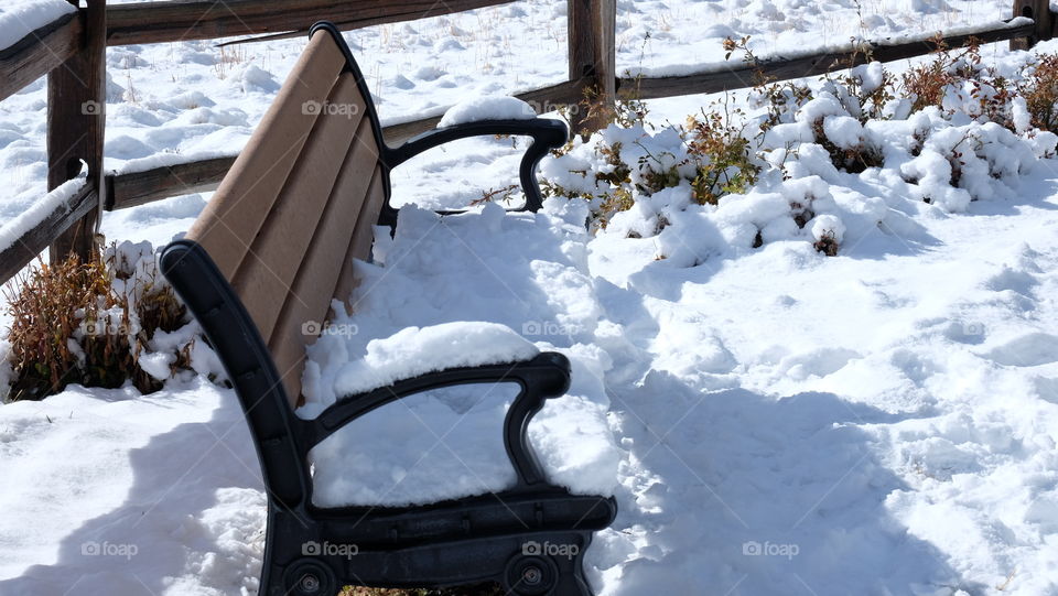 Snow covered bench