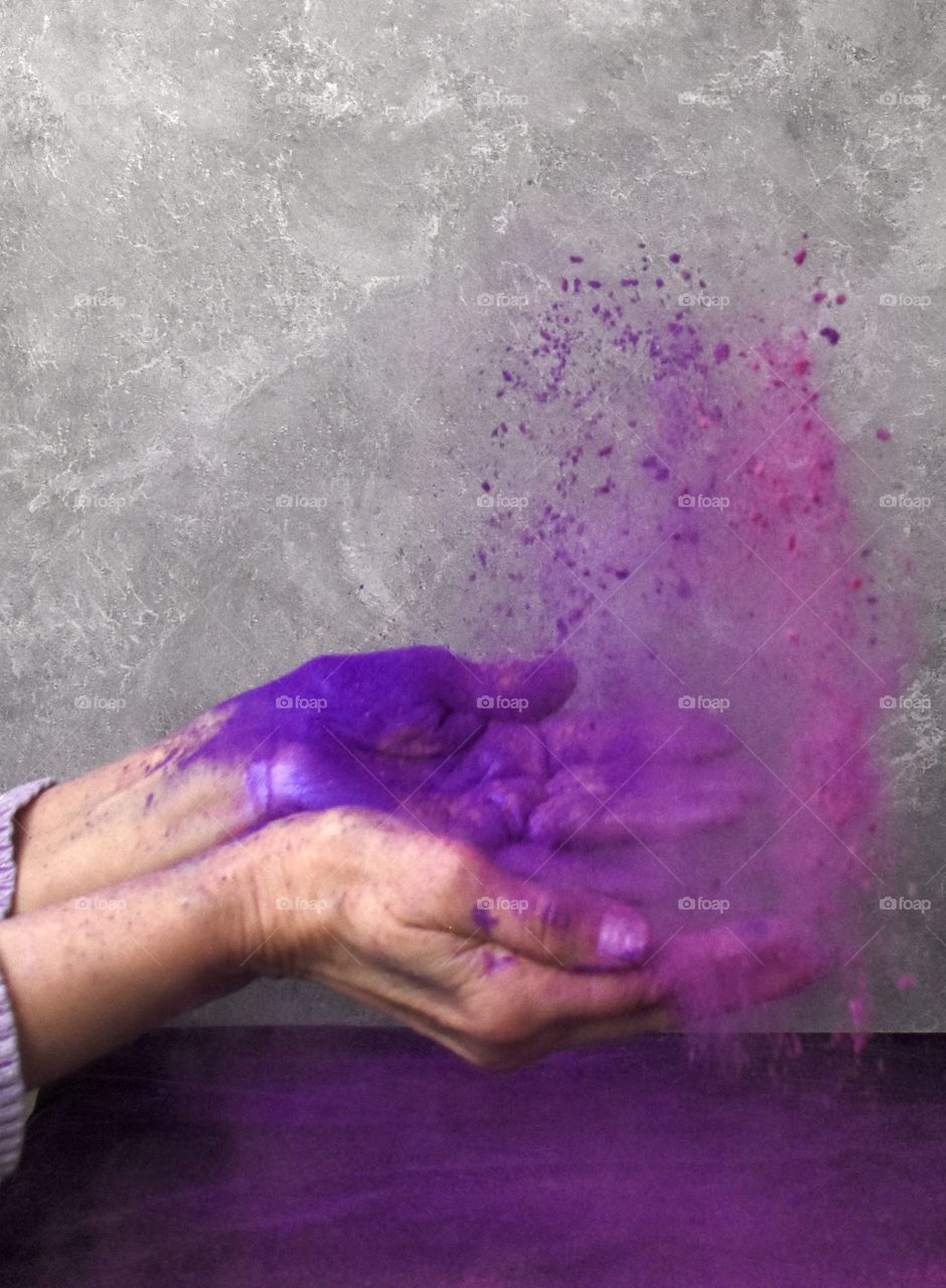 Woman tossing micro powder color in the air