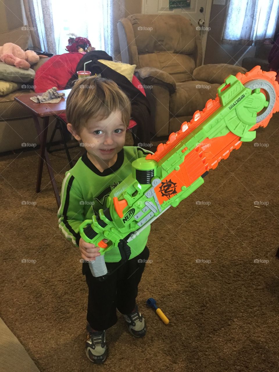 Small boy holding toy gun