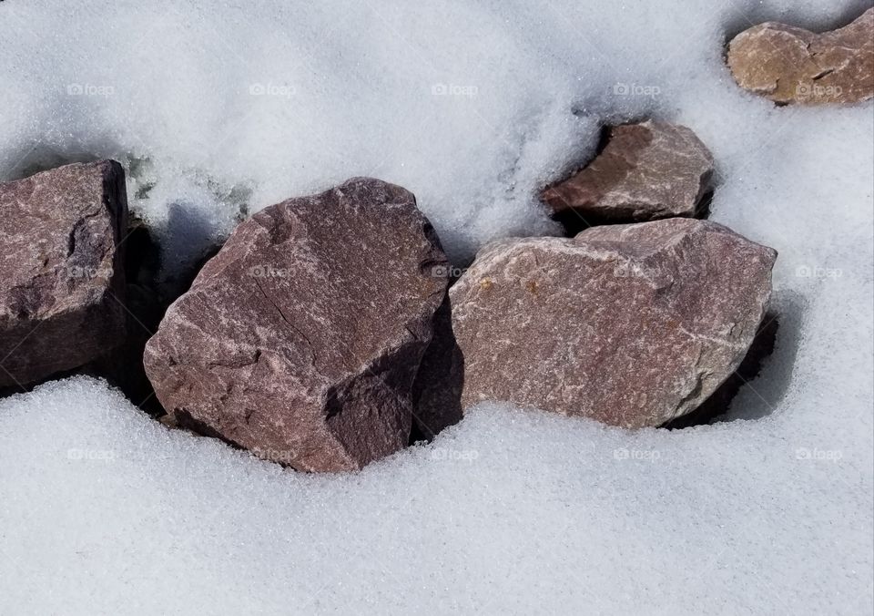 snow melting from the rock garden, warm rocks hurry the melting process, waiting for new green growth