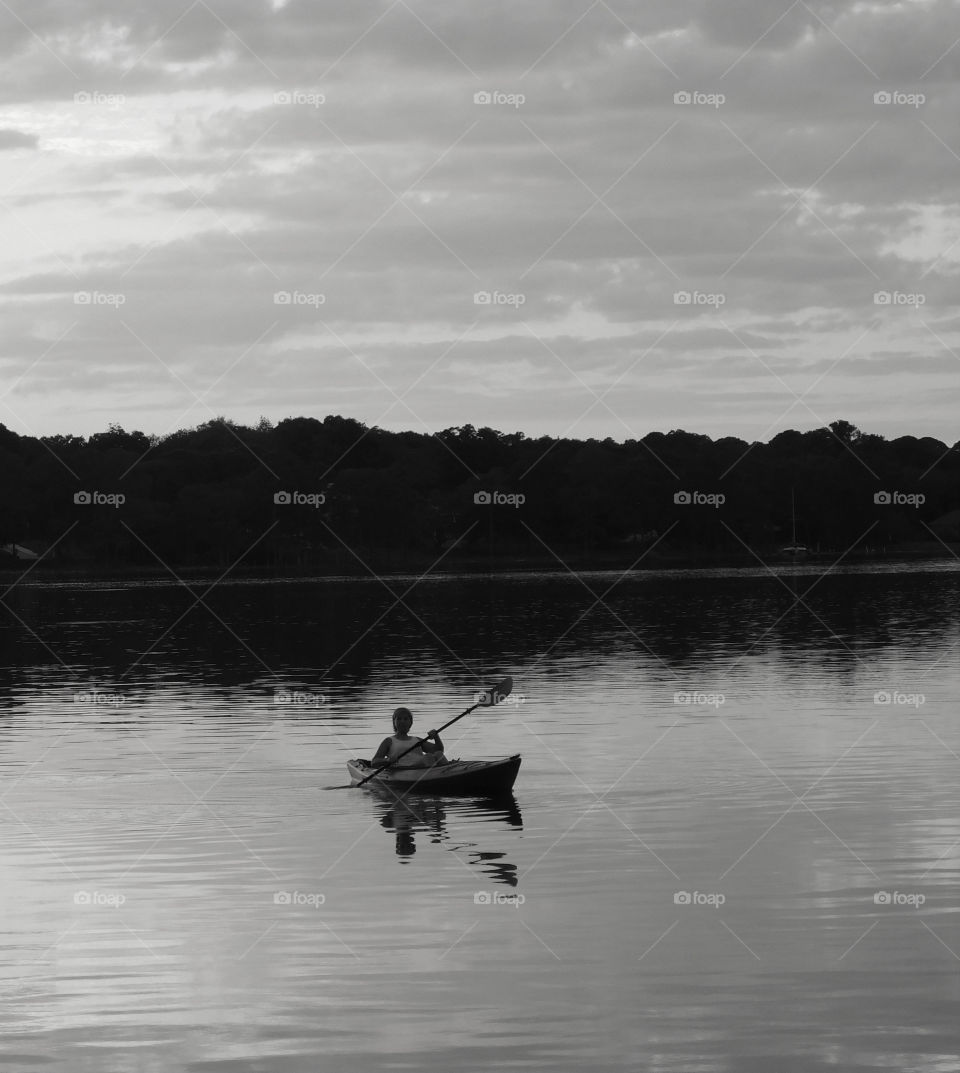 Kayaker on the bay. Kayaking is a great why to exercise while taking in all of natures beauty! This is a B&W photo of an amazing sunset!