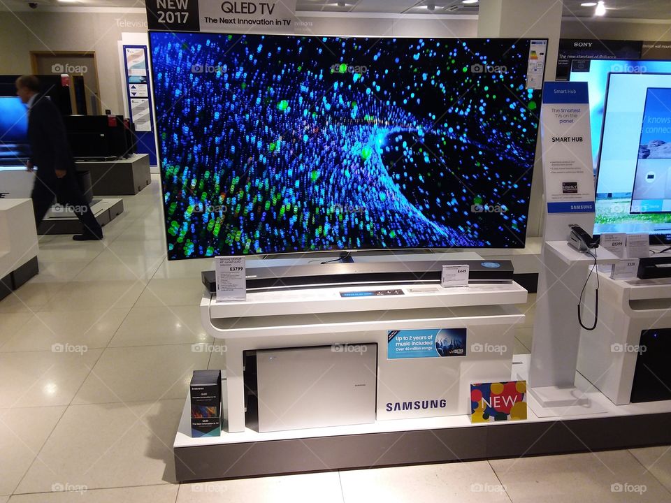 Samsung QLED television 4K Ultra High Definition TV with soundbar and sub-woofer on plinths at Peter Jones Display