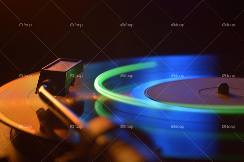 music vinyl record playing an old goamophone mixer neon effects long exposure recording sound