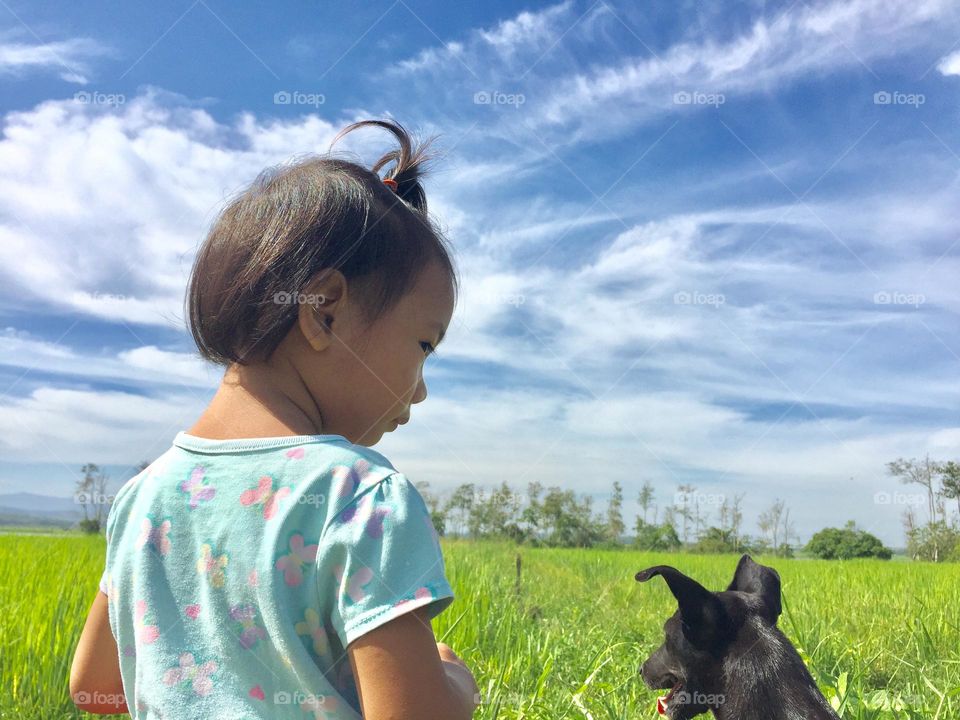Little girl and her momma doggy bonding together.