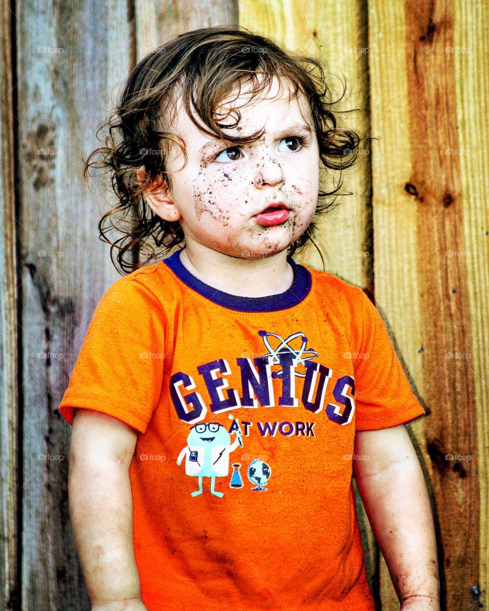 My son, the Genius playing in the mud. He was utterly confused, I must admit, as to why he couldn't climb over the fence.