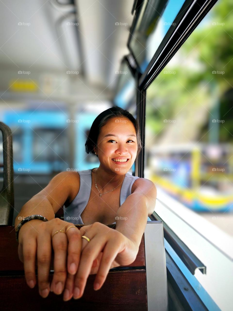 Lady happy on a tram ride on a sunny day