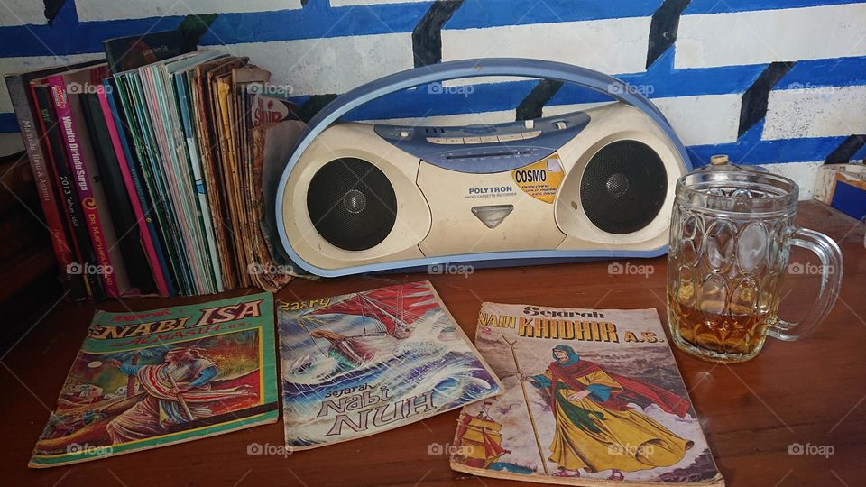 A Small Row of Old Books, a Compo Tape and a Glass of Tea