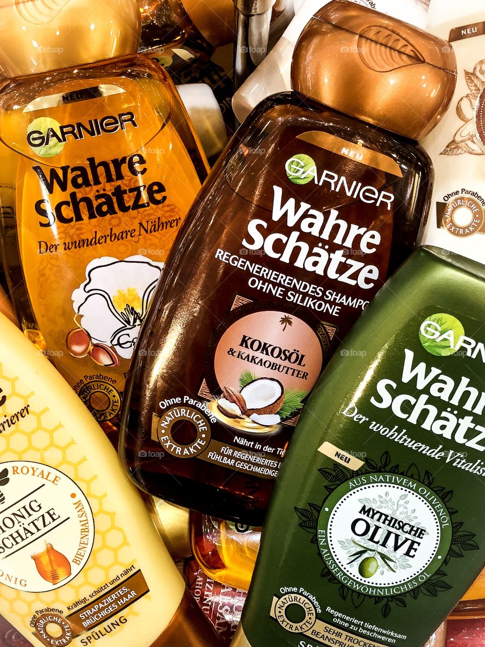 Multiple Garnier Hair shampoos and conditioners layered on each other