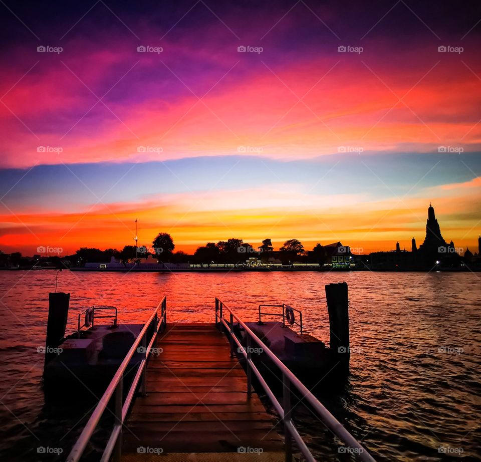 The sky over Bangkok lit up just as the sun went below the horizon. Wat Arun can be seen off to the left.
