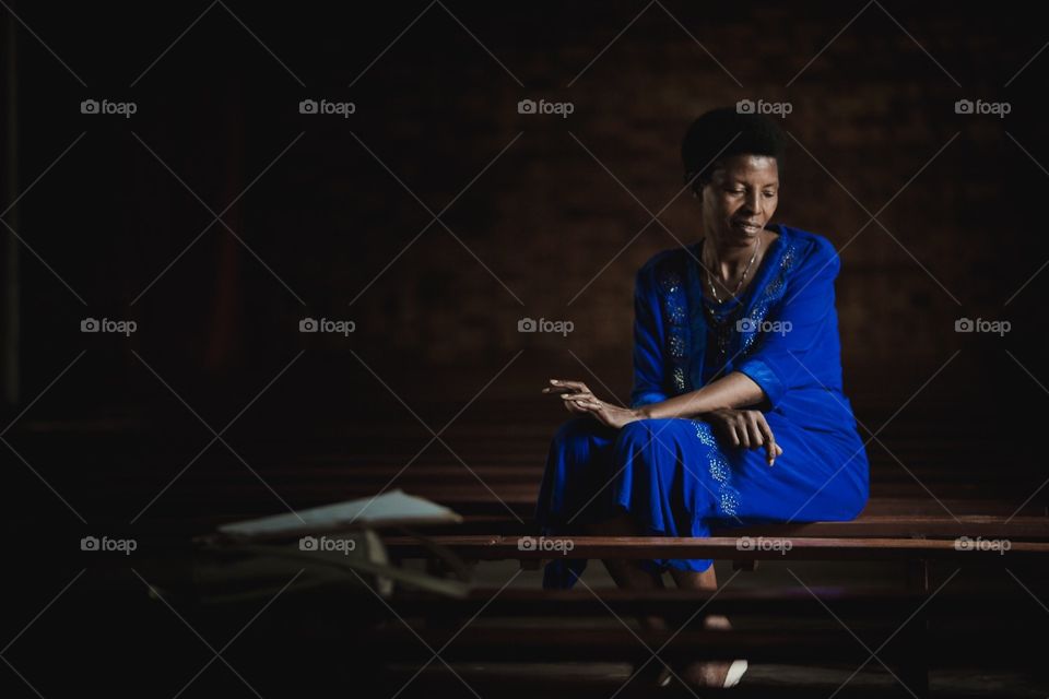Beautiful African Woman Portrait. A beautiful African woman sitting inside of a church in Rwanda
