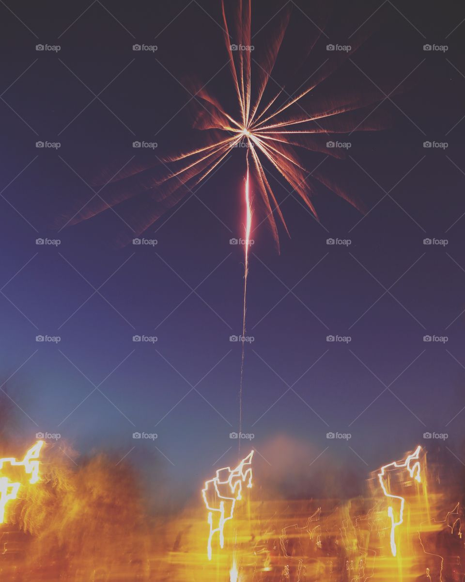 Beautiful single burst of a red firework, dark night sky
