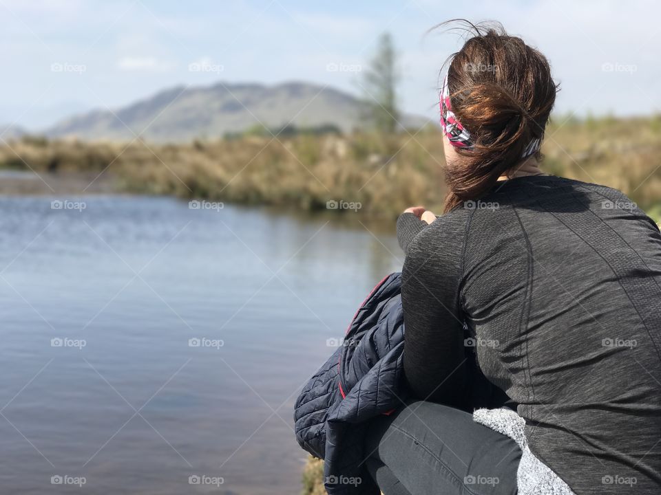 Girl relaxing at side of water