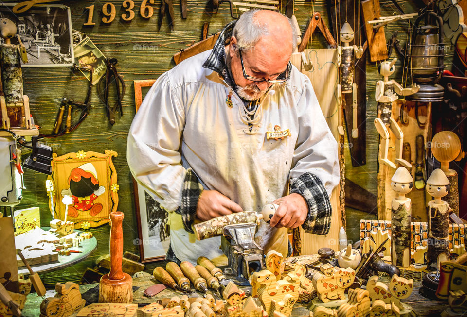 A Craftsman In The Workshop Making Wooden Toys
