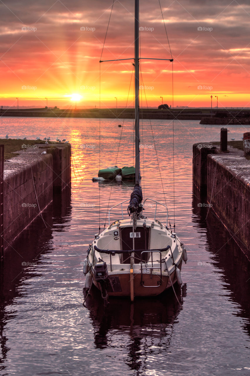 Sailboat in the marine at the sunrise