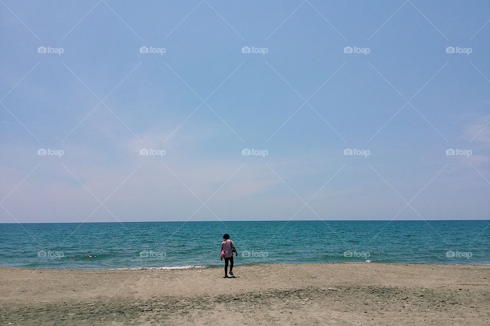 Man standing by the seashore.