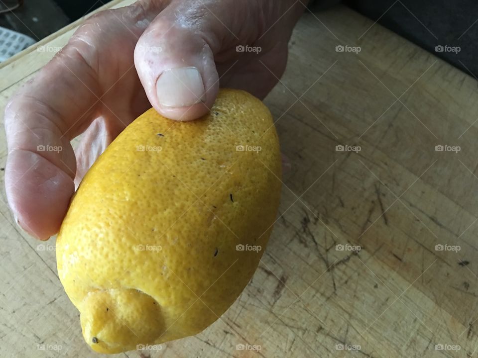 Hand holding lemon