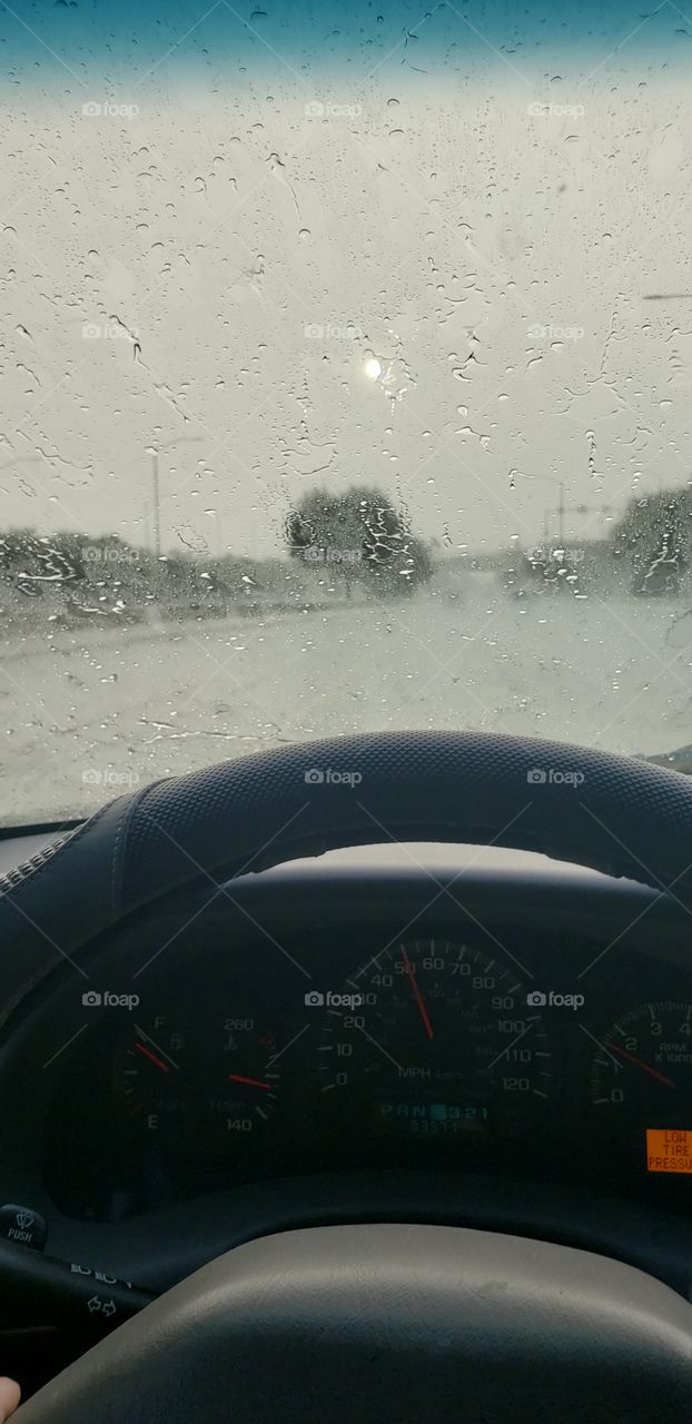 sun shining through the rain