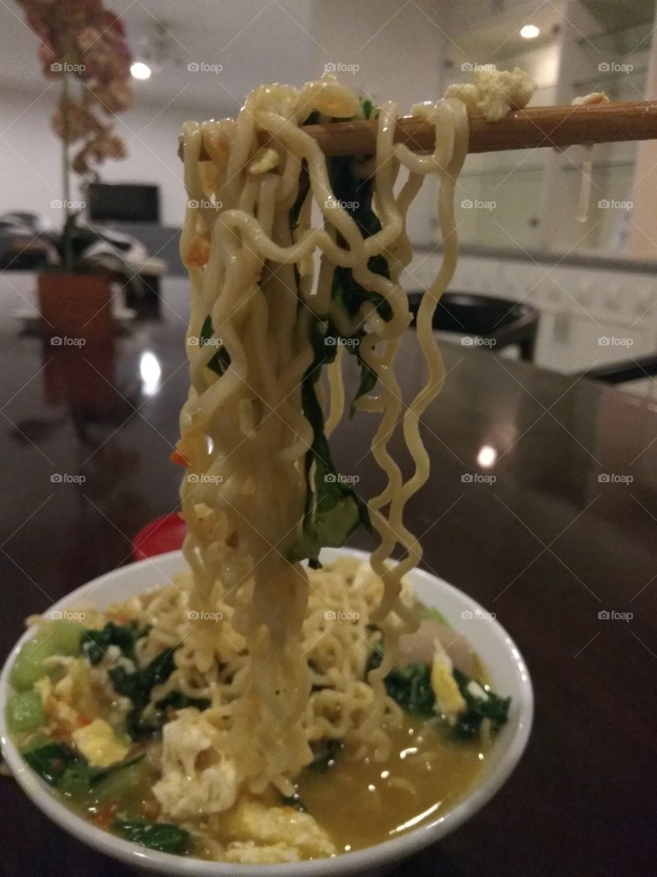 fast food noodles with chop stick on the table