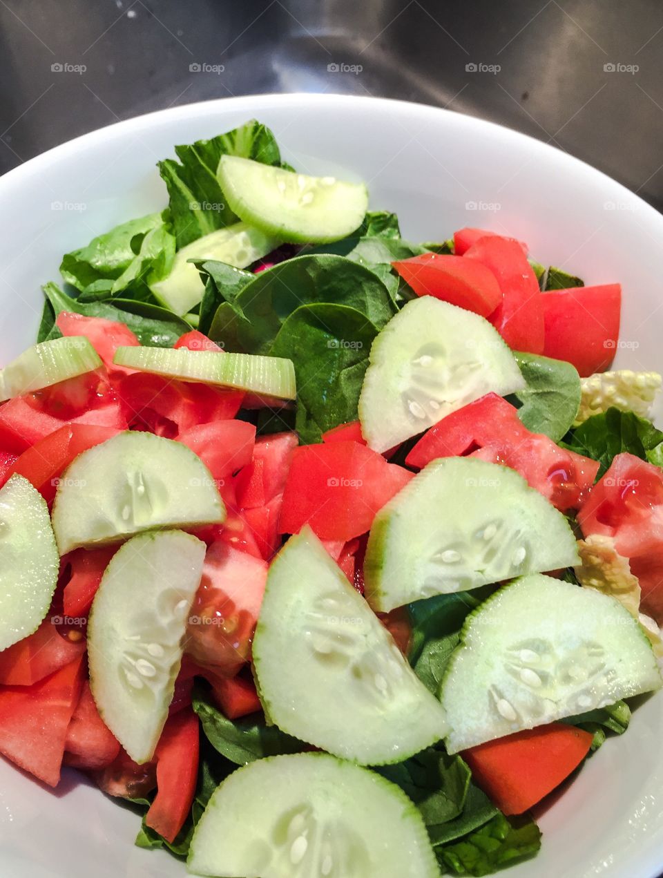 Salad. A refreshing healthy salad with chopped  cucumbers and tomatoes.