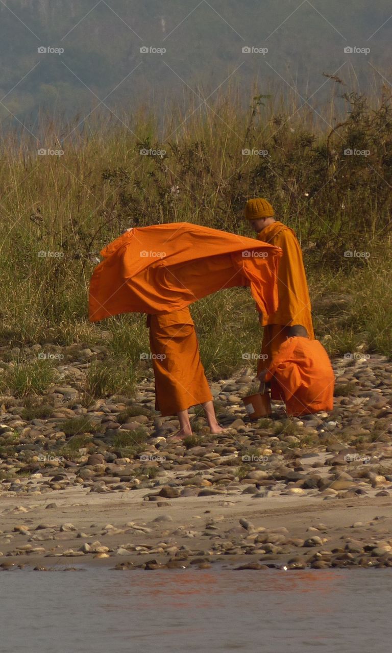Monks in the wind on the Mekong