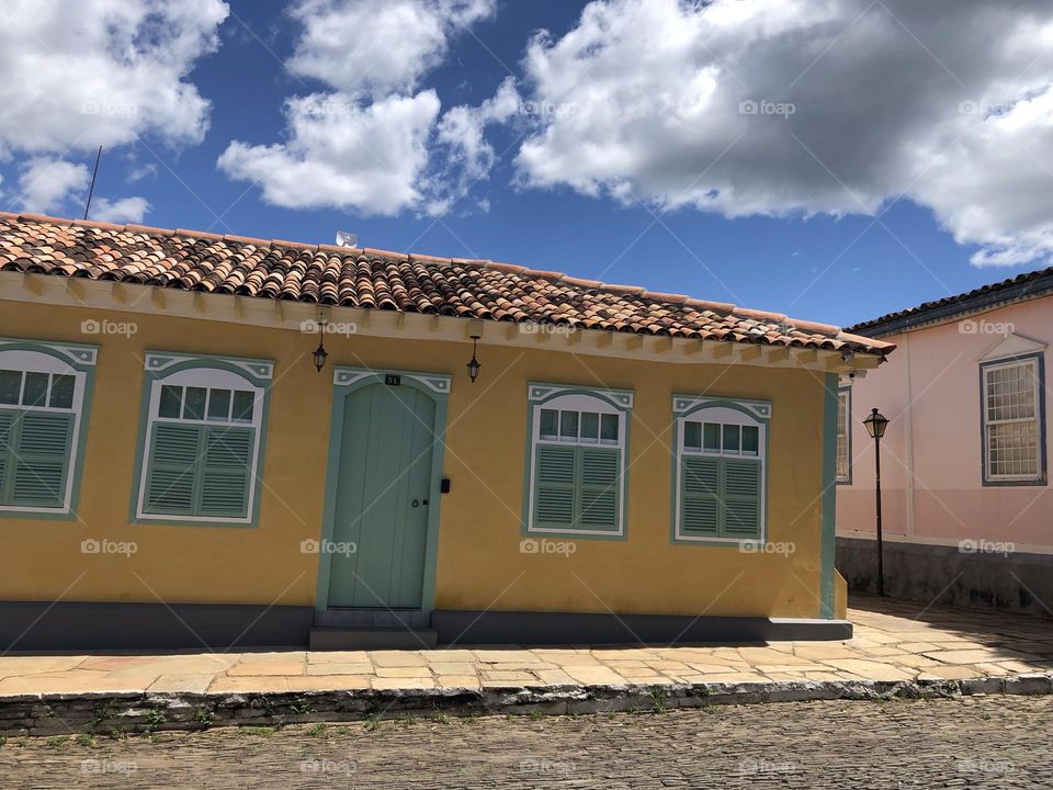 Antique historical house painted in yellow and green