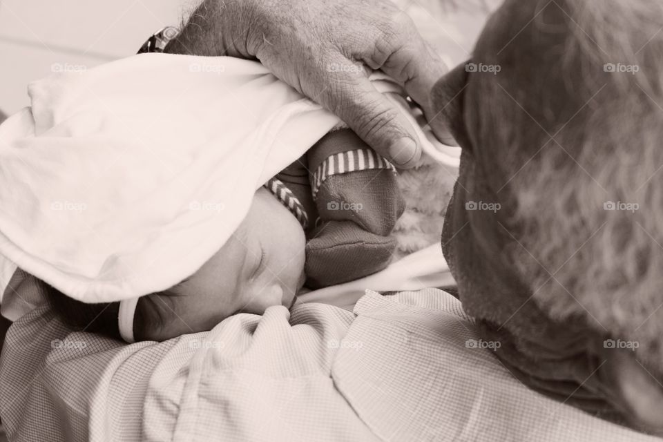 Moment when grandfather first meets granddaughter in black and white