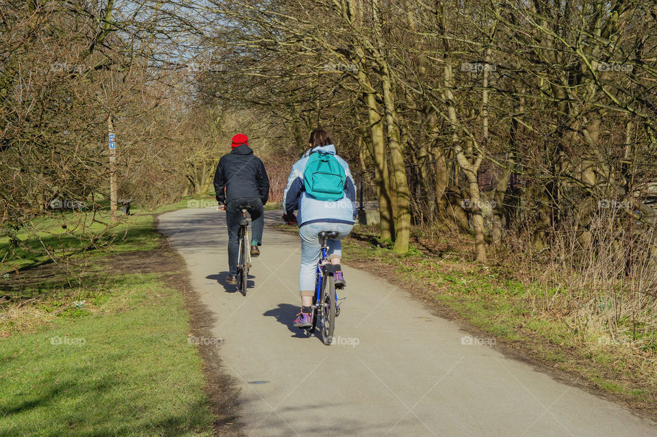 Cyclists . Cycling along path