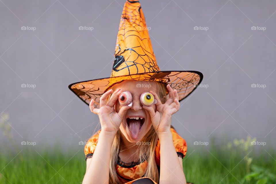 Happy kid celebrating Halloween outdoor 