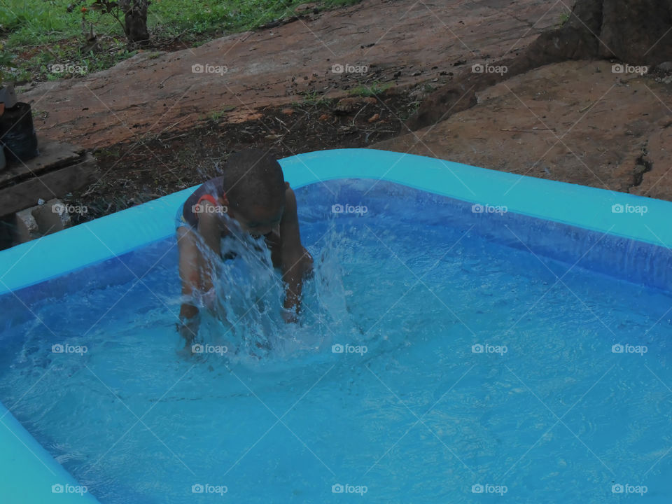 Child Making Splash in Pool