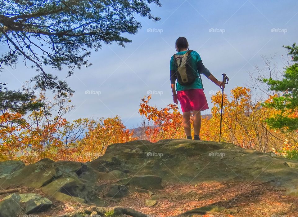 Hiker looking out at the mountains in the Autumn.