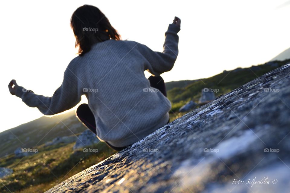 Meditation in Sunset . Woman meditating during Sunset in the Mountains 