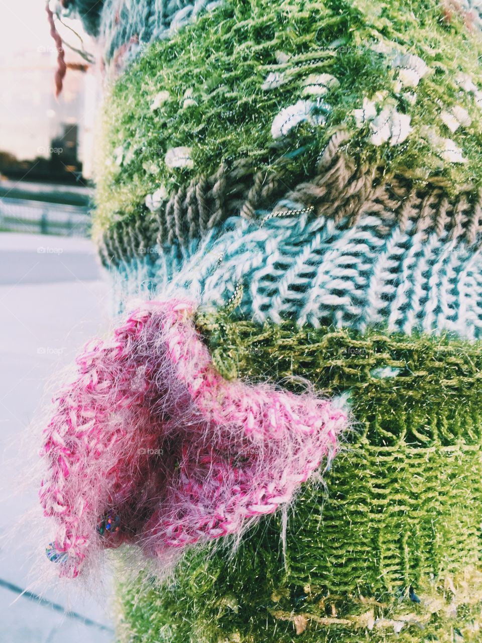 Yarn in different kind of colors knitted around a pole