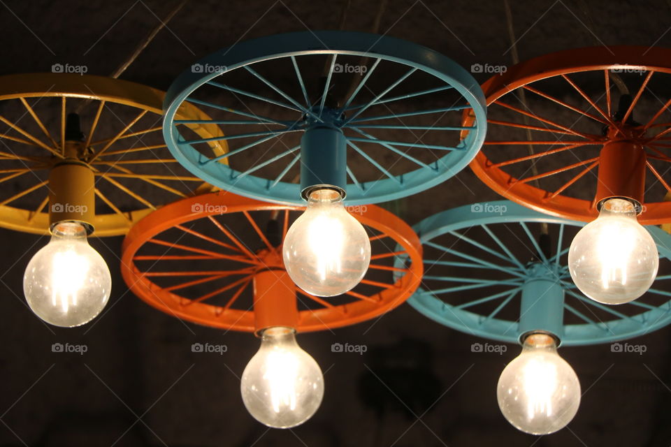 Lights hanging down of colorful wheels 