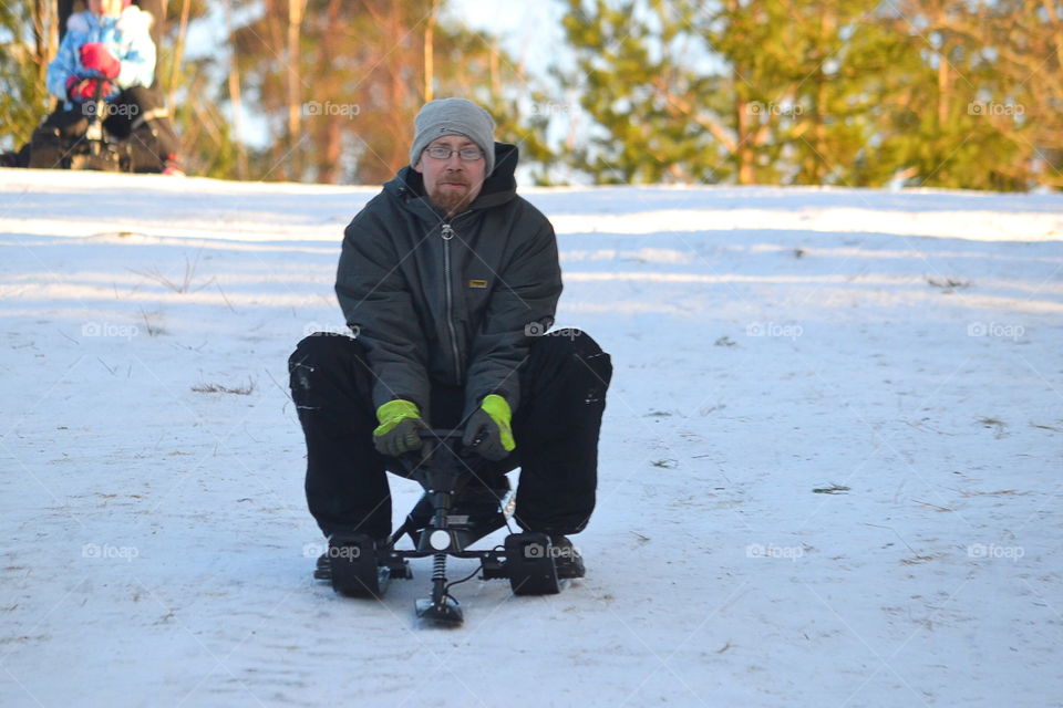 Adult man sledding