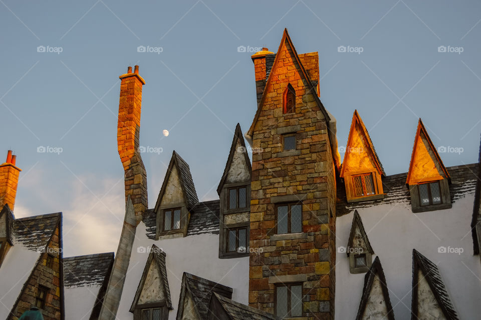Sunlit cabin with moon in the background