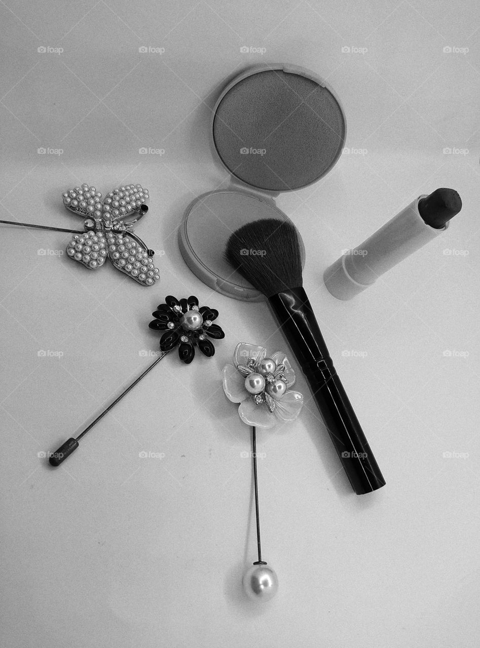 Compact powder, makeup brush and brooch decoration isolated on white background