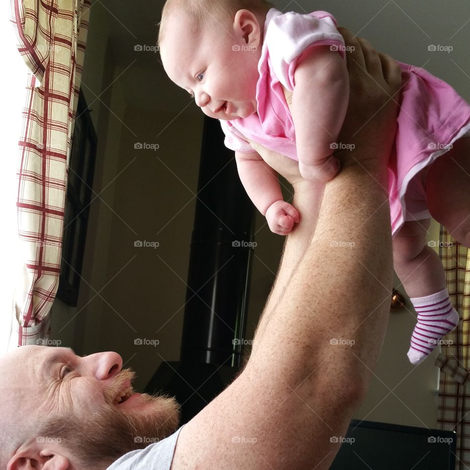 No greater love. Daddy spending some quality time with his baby girl. He would lift her up and she giggled every time!