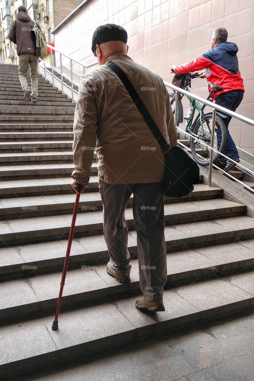 Took this picture when I was walking behind this old man. It's a challenge for this kind of people to walk on stairs where is no elevator. 