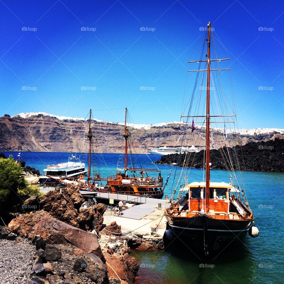 Sailing in Santorini, Greece. View  from the "caldera" volcano of santorini's pristine blue waters and iconic white architecture. 