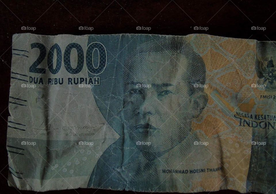 Indonesian Dollar (IDR) of 2,000 . Iconic person of Muhammad Husni Thamin, a National Hero of Indonesia from Betawi .