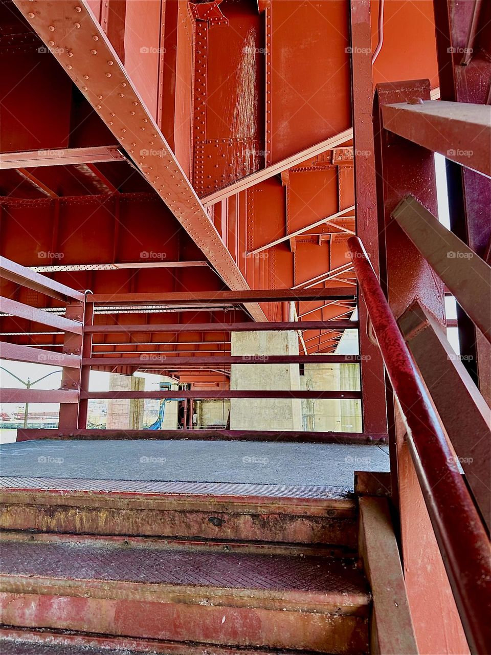 This is the red metal staircase of the “Pulaski Bridge” at “Newtown Creek” in LIC, Queens. The industrial minimalist aesthetic of this marvel of modern architecture reminds of the “Bauhaus” school of the 1930s. 2024. Hypnotic Productions
