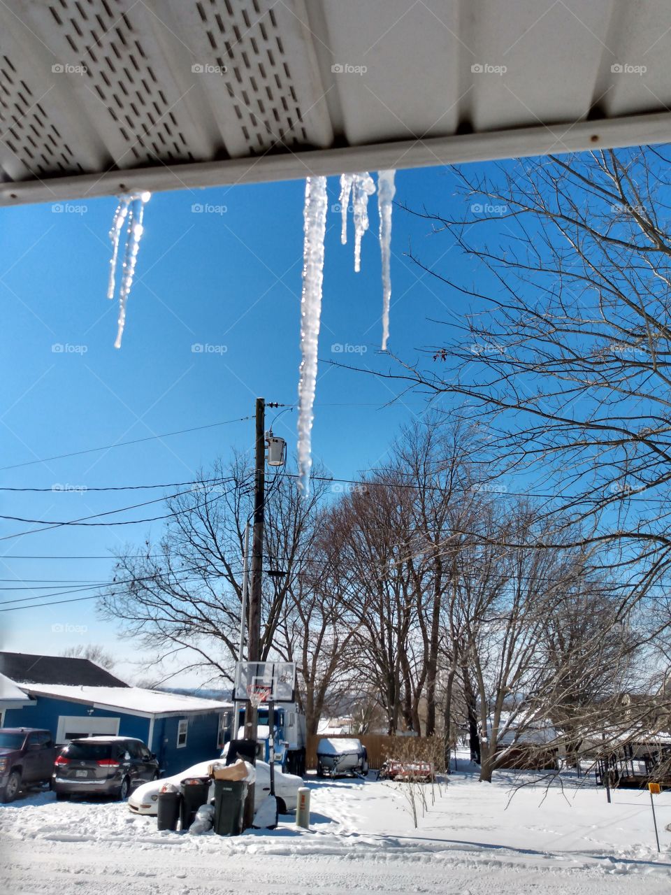 as the sun glistens through the icecicles each one begins to melt quickly,soon will be gone.