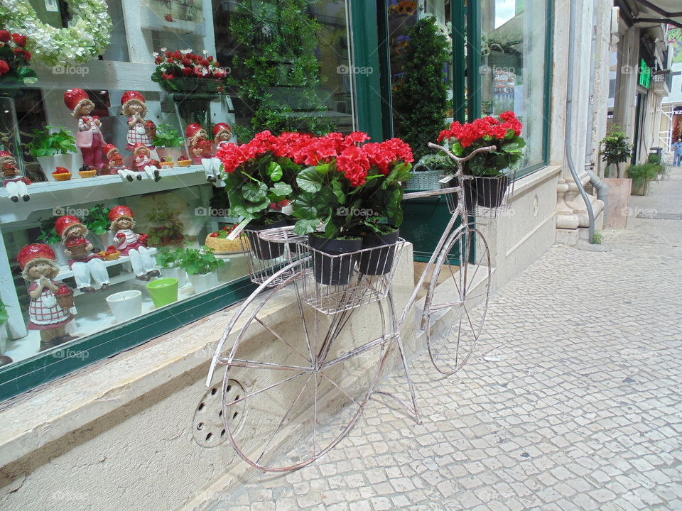 A bike with flowers on a street